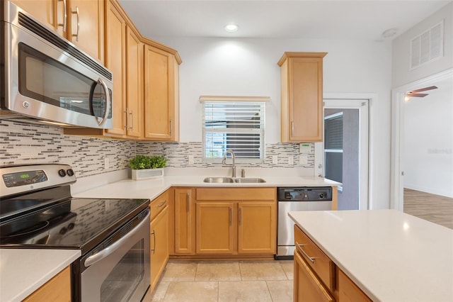 kitchen with appliances with stainless steel finishes, sink, and backsplash