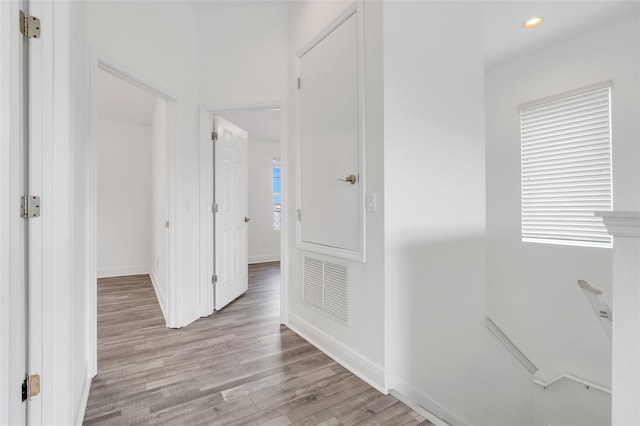 hall featuring plenty of natural light and light hardwood / wood-style floors