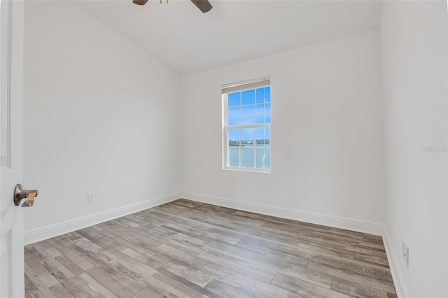 empty room with lofted ceiling, ceiling fan, and light hardwood / wood-style flooring