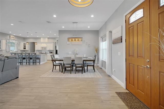 dining space with light wood-type flooring