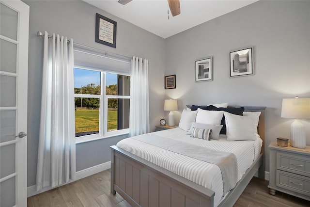 bedroom with ceiling fan and light hardwood / wood-style floors