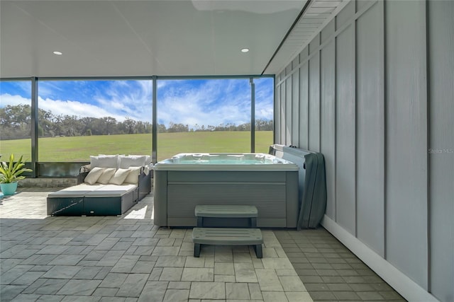 sunroom / solarium with a hot tub and a wealth of natural light