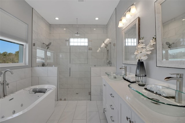 bathroom with tile patterned floors, vanity, plus walk in shower, and tile walls