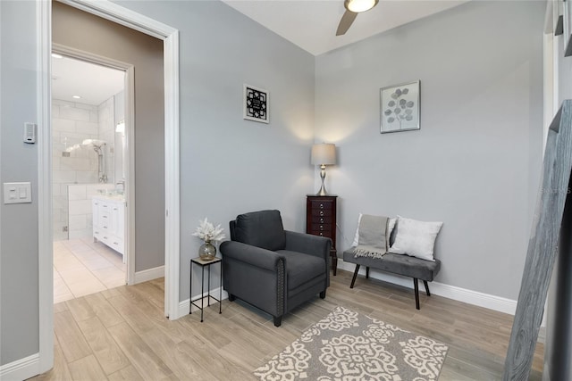 sitting room featuring ceiling fan and light hardwood / wood-style flooring