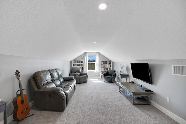 carpeted living room with lofted ceiling and a textured ceiling