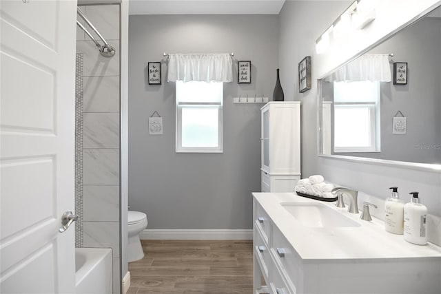 bathroom featuring vanity, wood-type flooring, and toilet