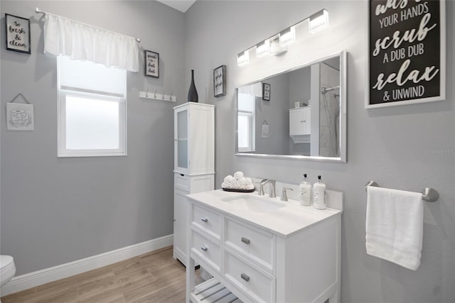 bathroom featuring hardwood / wood-style flooring, vanity, curtained shower, and toilet