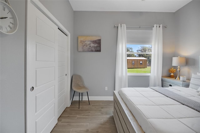 bedroom featuring light hardwood / wood-style floors and a closet