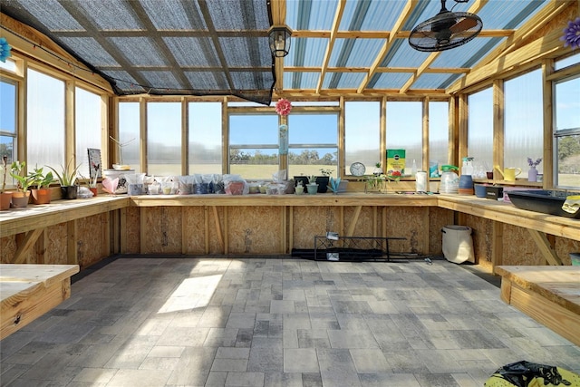 sunroom / solarium featuring vaulted ceiling