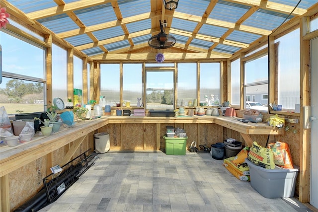 unfurnished sunroom with vaulted ceiling