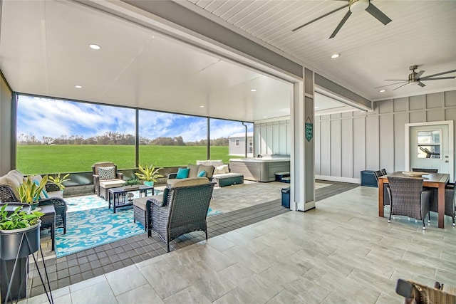 sunroom / solarium featuring ceiling fan