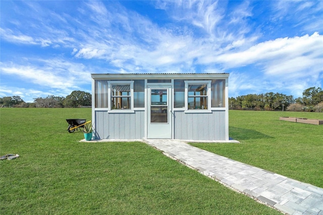 view of outbuilding with a yard