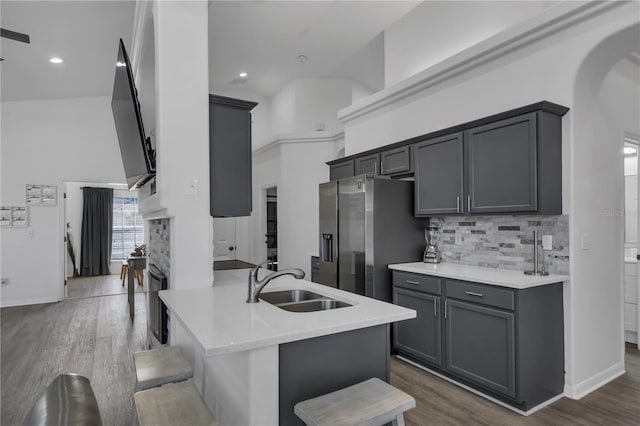 kitchen with a kitchen breakfast bar, gray cabinets, and sink