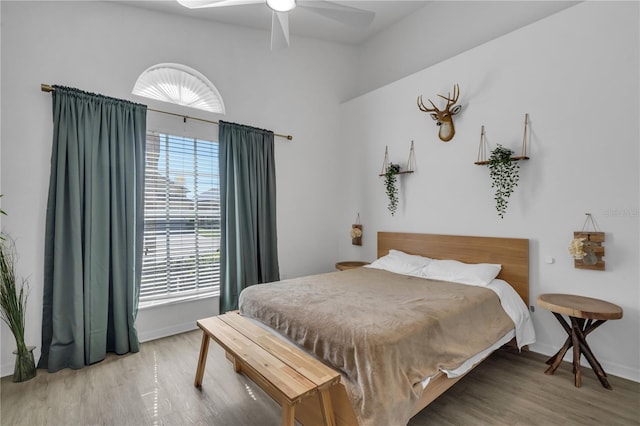 bedroom with hardwood / wood-style floors and ceiling fan