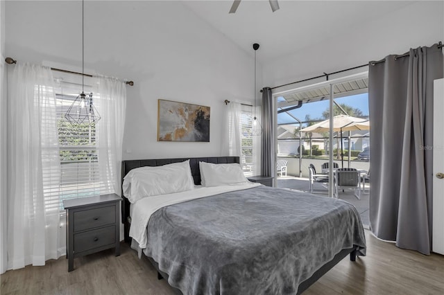 bedroom featuring ceiling fan, high vaulted ceiling, access to outside, and hardwood / wood-style floors