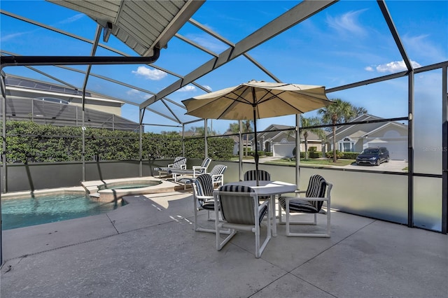 view of patio / terrace featuring a lanai and a pool with hot tub