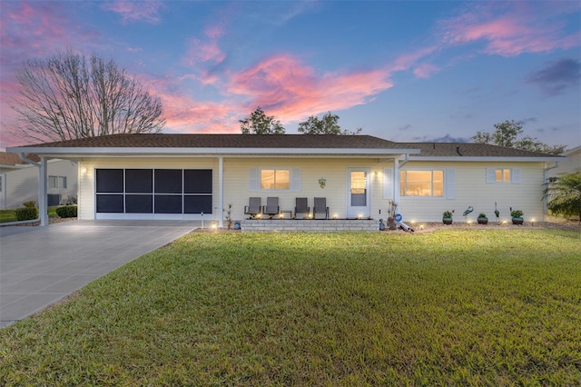 ranch-style house featuring a yard and a garage