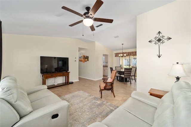 tiled living room with ceiling fan with notable chandelier and vaulted ceiling