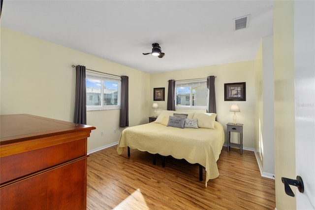 bedroom featuring light hardwood / wood-style flooring and multiple windows