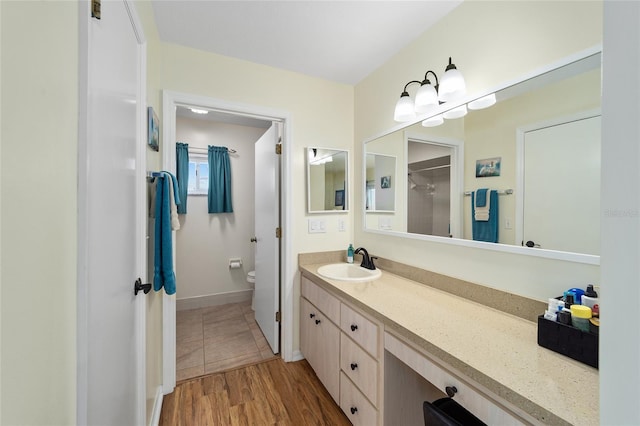 bathroom featuring hardwood / wood-style flooring, vanity, and toilet