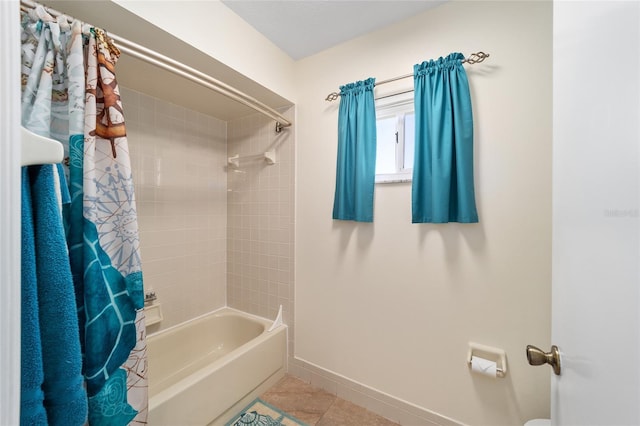 bathroom featuring shower / bathtub combination with curtain and tile patterned flooring