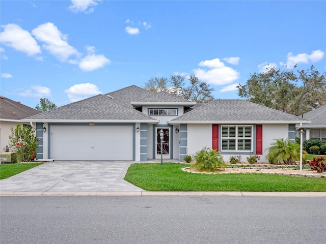 view of front facade featuring a garage and a front lawn