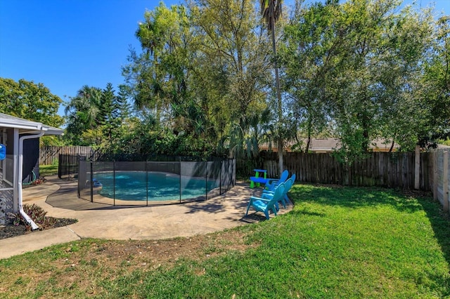 view of pool featuring a yard, a fenced in pool, a fenced backyard, and a patio area