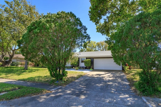 view of front of property with concrete driveway, a garage, and a front yard