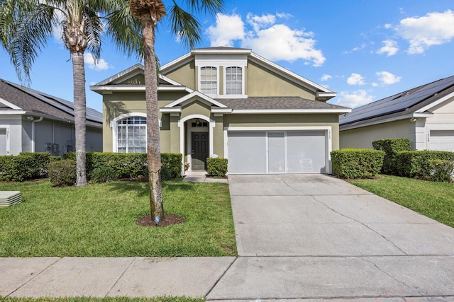 view of front of home with a front yard and a garage