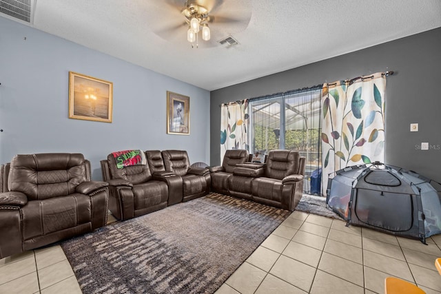 cinema featuring light tile patterned floors, ceiling fan, and a textured ceiling