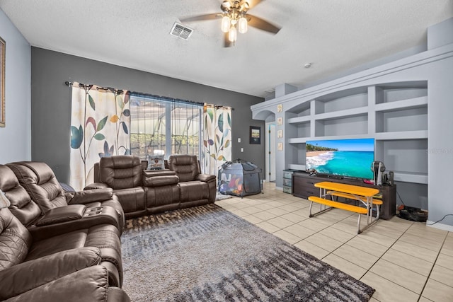 tiled living room featuring a textured ceiling, built in shelves, and ceiling fan