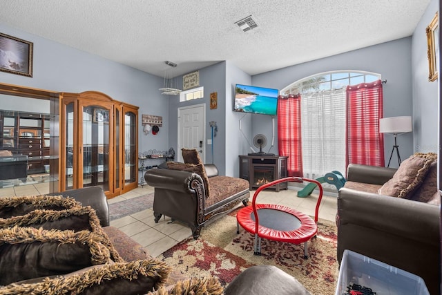 living room featuring light tile patterned floors and a textured ceiling