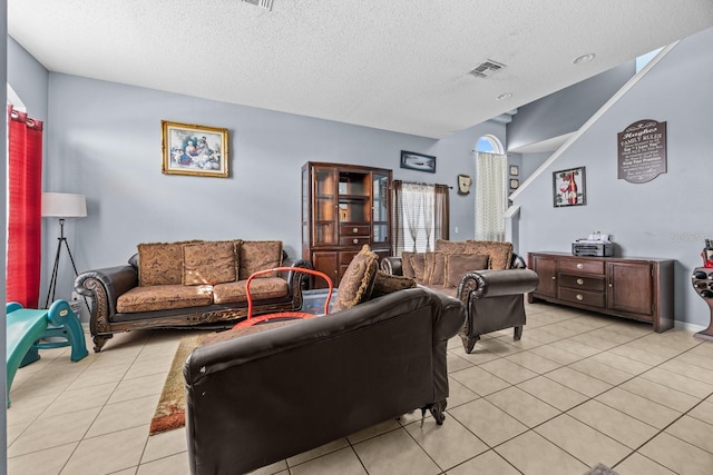 tiled living room with a textured ceiling