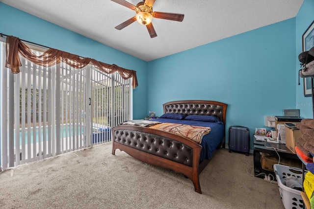 carpeted bedroom featuring ceiling fan, access to exterior, and a textured ceiling