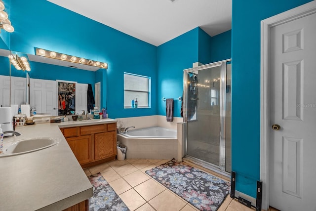 bathroom featuring separate shower and tub, vanity, and tile patterned flooring