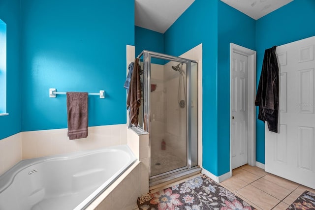 bathroom featuring plus walk in shower and tile patterned flooring