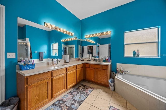 bathroom featuring tile patterned floors, plus walk in shower, and vanity