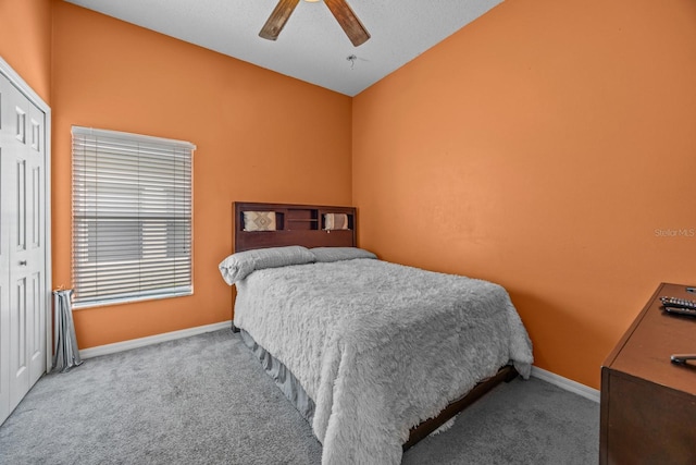 bedroom with light carpet, vaulted ceiling, ceiling fan, and a closet