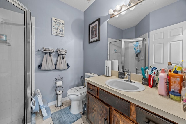 bathroom featuring tile patterned floors, vanity, a shower with shower door, and toilet