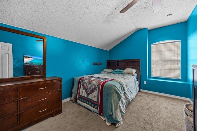 carpeted bedroom with ceiling fan, vaulted ceiling, and a textured ceiling