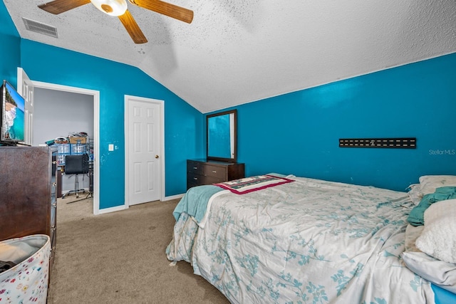 carpeted bedroom featuring vaulted ceiling, ceiling fan, and a textured ceiling