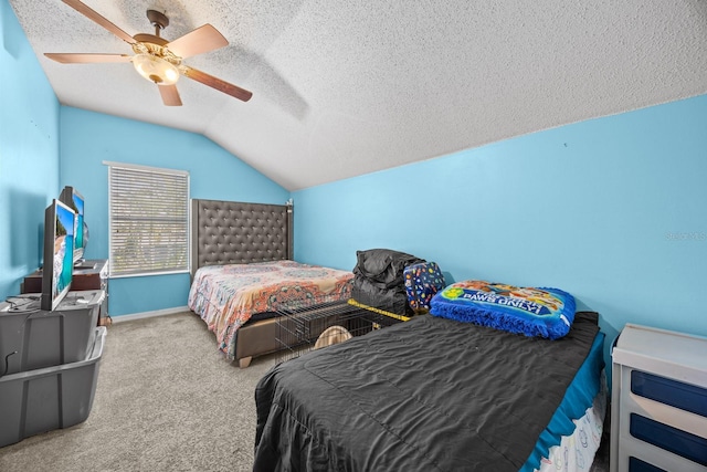 carpeted bedroom with a textured ceiling, vaulted ceiling, and ceiling fan