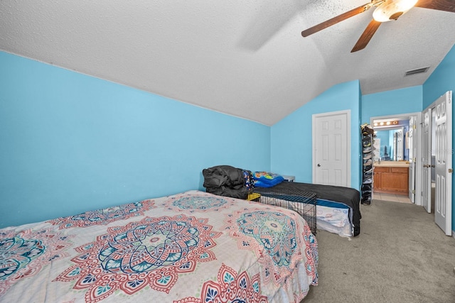 carpeted bedroom featuring ceiling fan, vaulted ceiling, and a textured ceiling