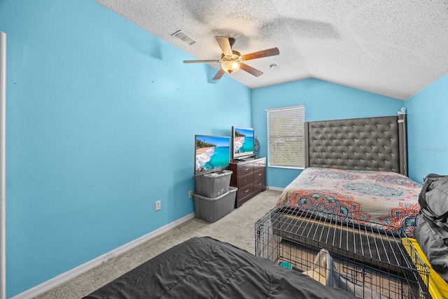 bedroom with light carpet, vaulted ceiling, ceiling fan, and a textured ceiling