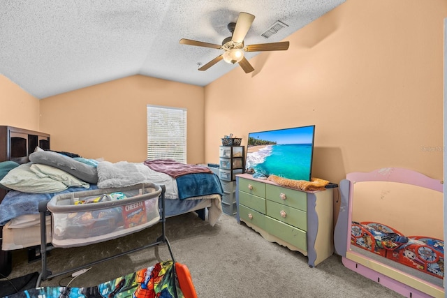 carpeted bedroom with lofted ceiling, ceiling fan, and a textured ceiling