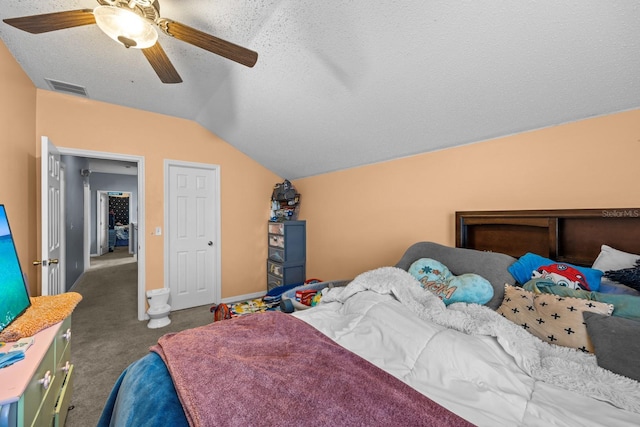 bedroom with lofted ceiling, ceiling fan, carpet floors, and a textured ceiling