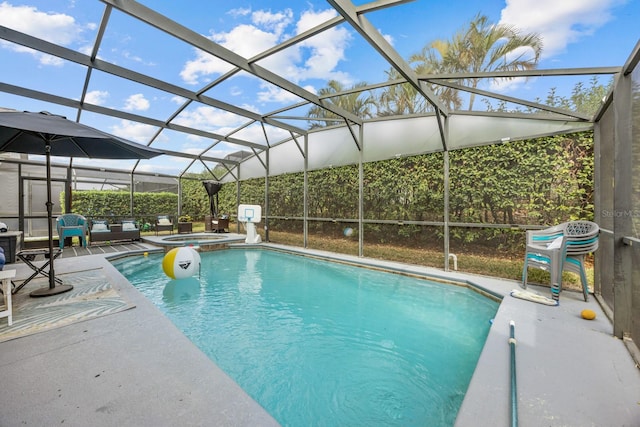 view of pool with a patio, an in ground hot tub, and glass enclosure