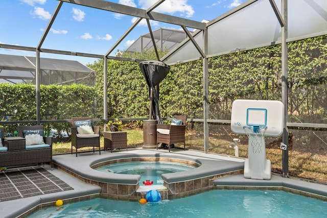 view of swimming pool with a patio area, an in ground hot tub, and glass enclosure