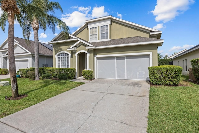 view of front of home with a front yard and a garage