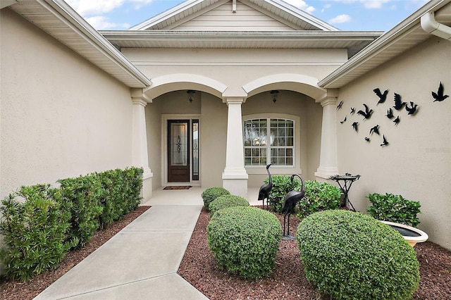 property entrance with stucco siding